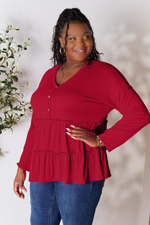 a woman standing in front of a white wall