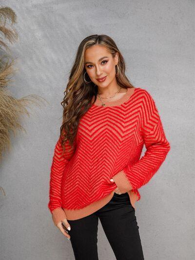 a woman wearing a red sweater and black pants