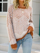 a woman wearing a brown and white sweater and jeans