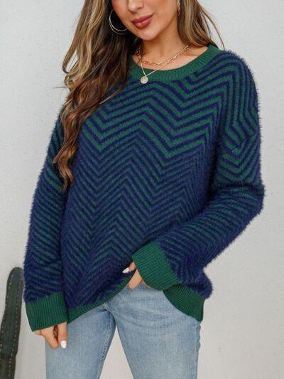 a woman wearing a green and blue sweater
