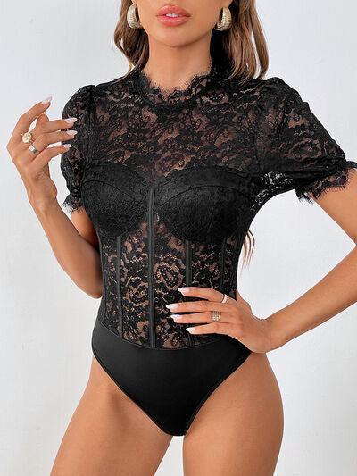 a woman in a black bodysuit with a lace top