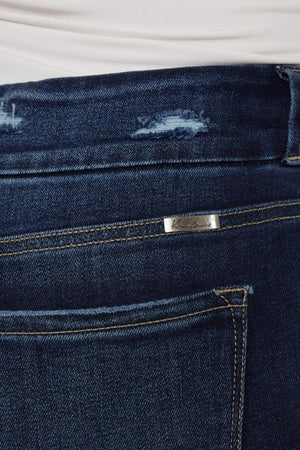 a close up of a person's jeans with a hole in the back pocket