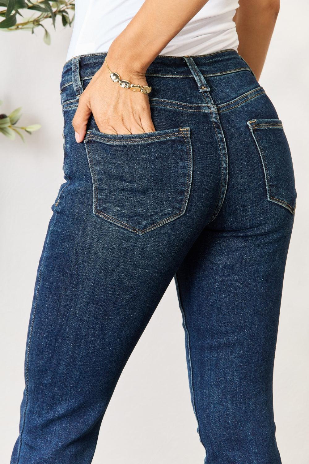 a woman in jeans with her hand in her pocket