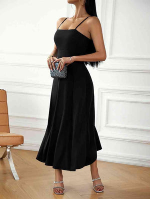 a woman in a black dress holding a purse