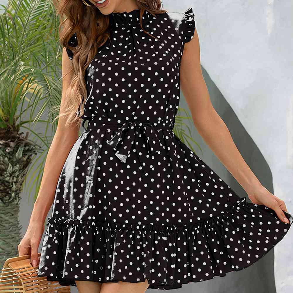 a woman in a black and white polka dot dress