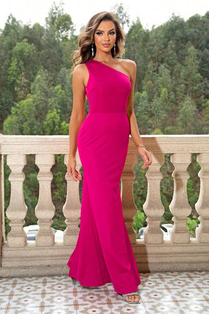 a woman in a pink dress standing on a balcony