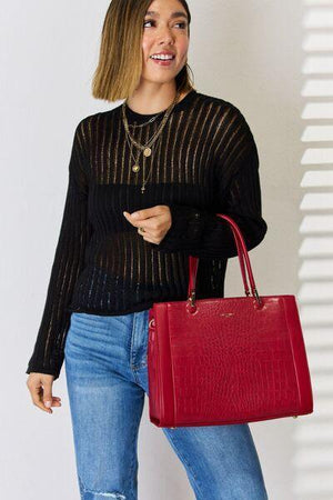 a woman holding a red purse and smiling
