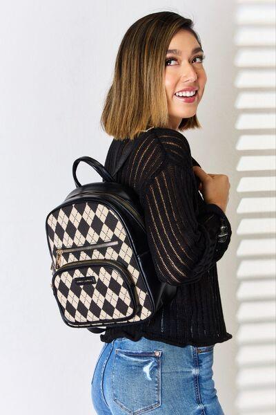 a woman wearing a black and white checkered backpack