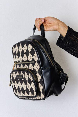 a person holding a black and white backpack