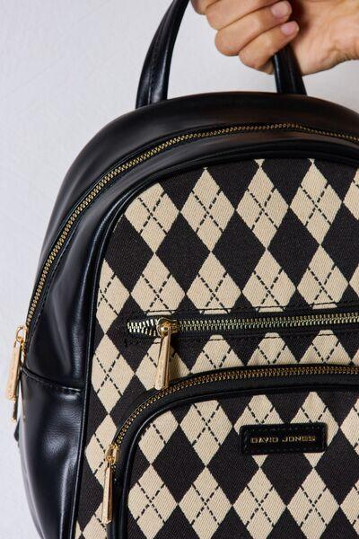 a person holding a black and white checkered backpack