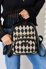a woman holding a black and white backpack