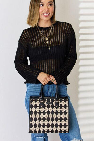 a woman holding a black and white checkered purse