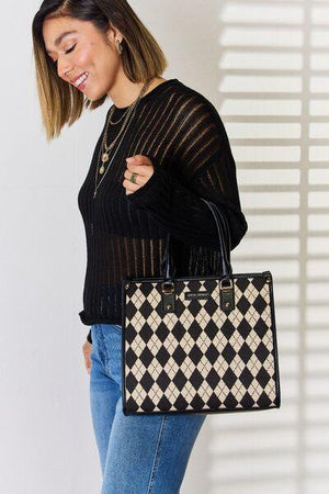 a woman holding a black and white checkered purse