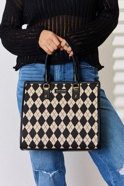 a woman holding a black and white purse