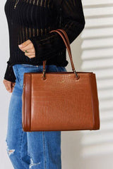 a woman is holding a brown handbag