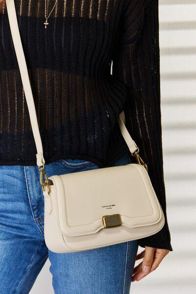 a woman is holding a white purse