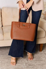 a woman holding a brown purse standing next to a couch