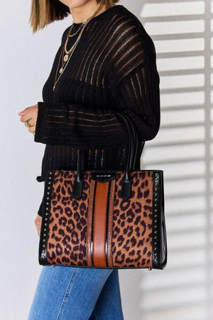 a woman carrying a leopard print purse