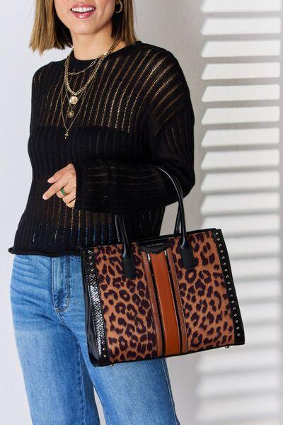 a woman holding a leopard print purse