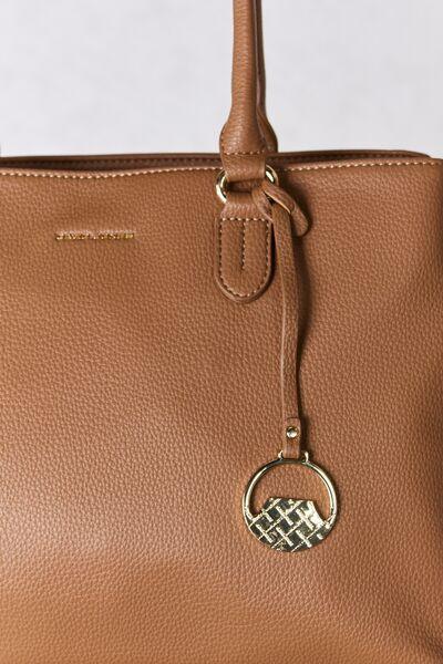 a brown purse with a metal ring on the handle