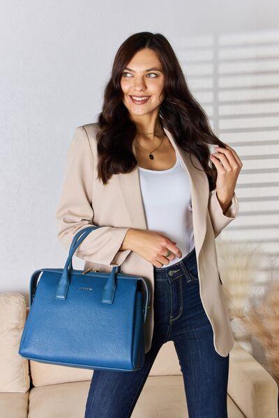 a woman holding a blue purse and smiling