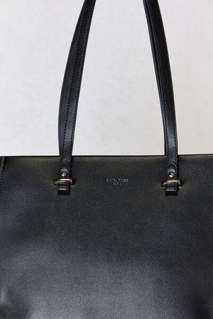 a black leather handbag on a white background