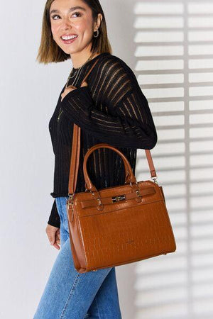 a woman holding a brown purse and smiling