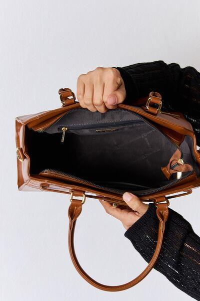 a person holding a brown purse in their hand