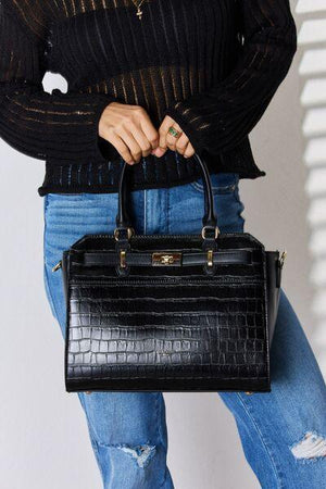 a woman holding a black handbag in her right hand