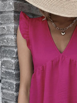 a woman wearing a pink top and a straw hat