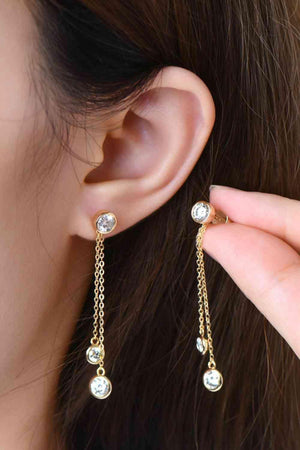 a close up of a person wearing a pair of earrings