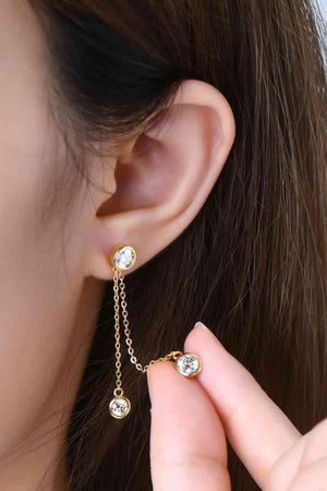 a close up of a person wearing a pair of earrings