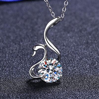 a swan necklace with a crystal stone in the shape of a heart