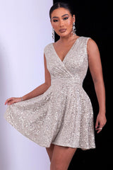 a woman in a silver dress posing for a picture