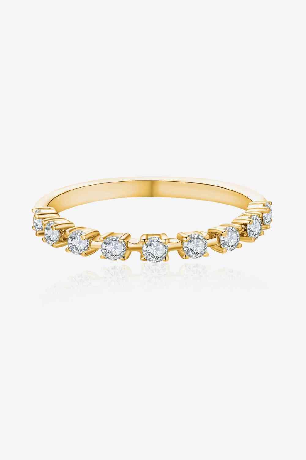 a yellow gold ring with a row of diamonds