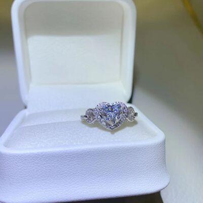 a heart shaped diamond ring in a white box