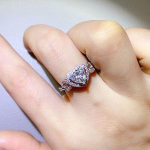 a woman's hand with a diamond ring on it