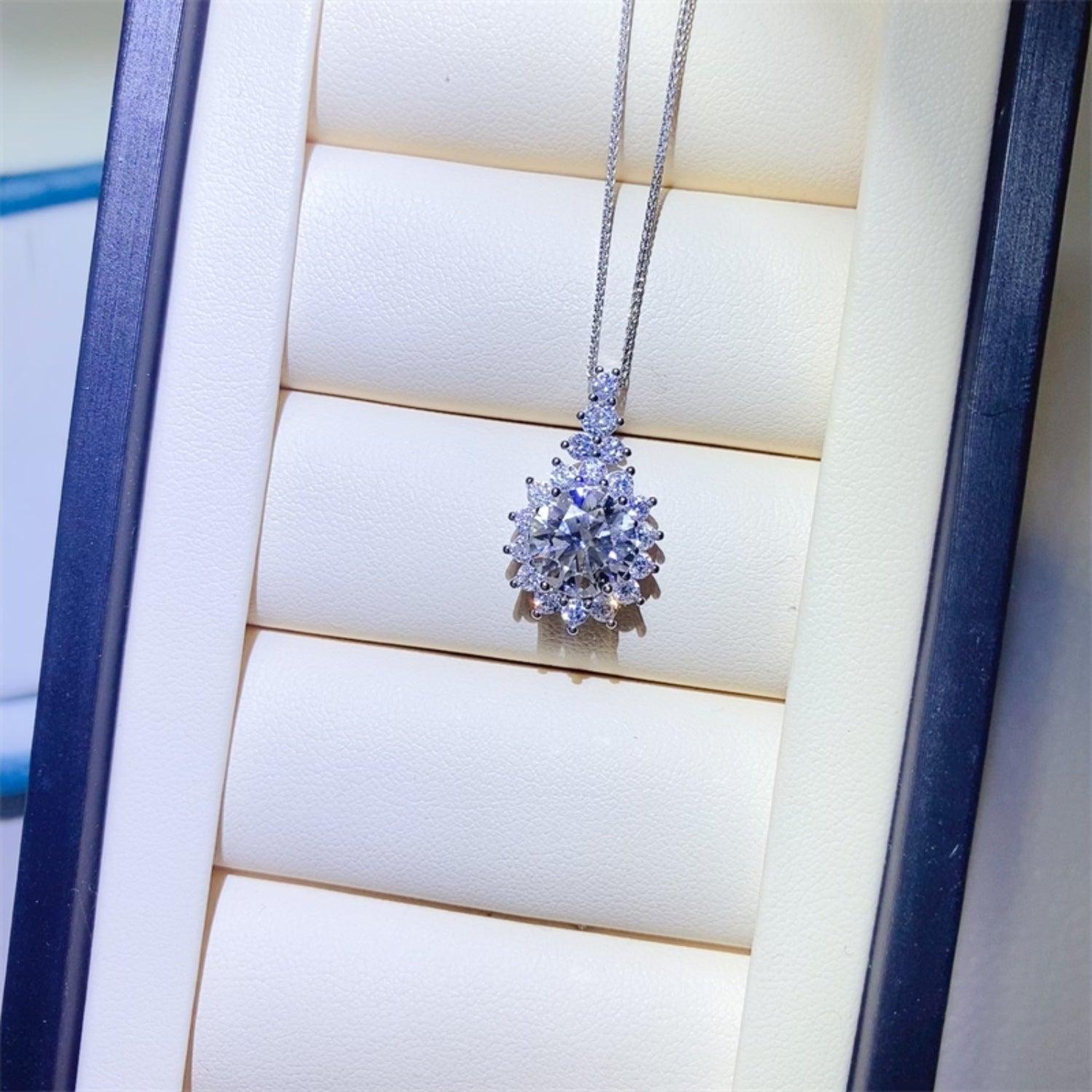 a necklace with a cluster of diamonds on it