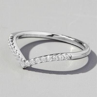 a close up of a diamond ring on a white surface