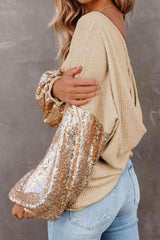 a woman wearing a gold sequin shoulder bag