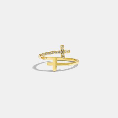 a gold ring with a cross on it