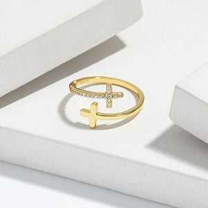 a cross ring sitting on top of a white box