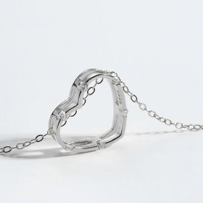 a silver heart shaped pendant on a chain