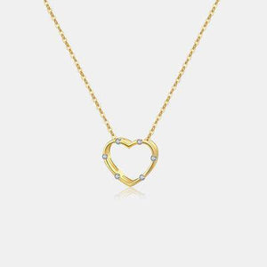 a gold necklace with a heart shaped pendant