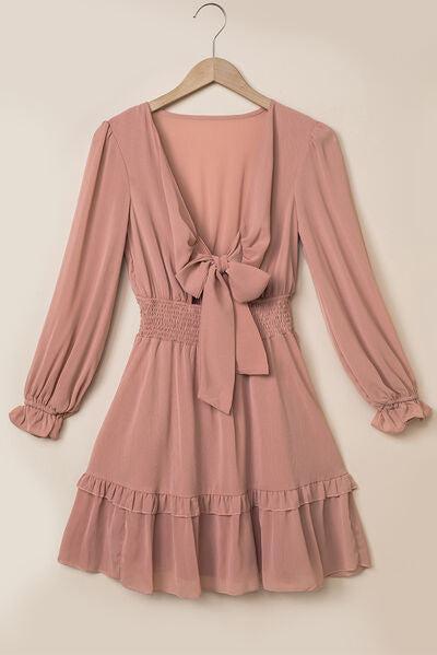 a pink dress hanging on a hanger