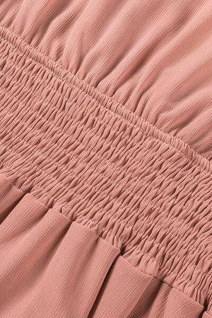 a close up of a pink dress with ruffles