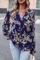 a woman wearing a floral blouse and jeans