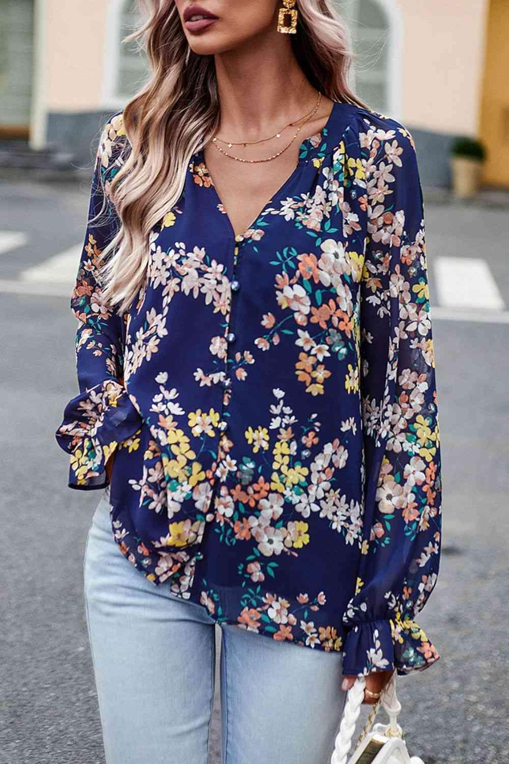 a woman wearing a floral blouse and jeans