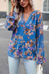 a woman wearing a blue floral blouse and jeans