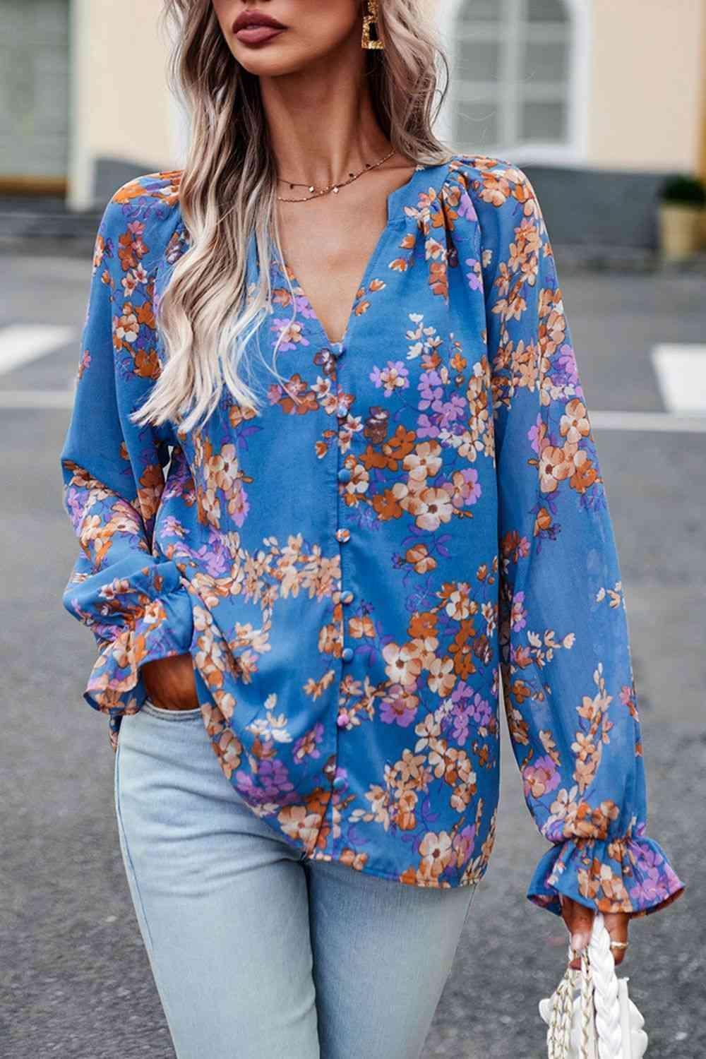 a woman wearing a blue floral blouse and jeans